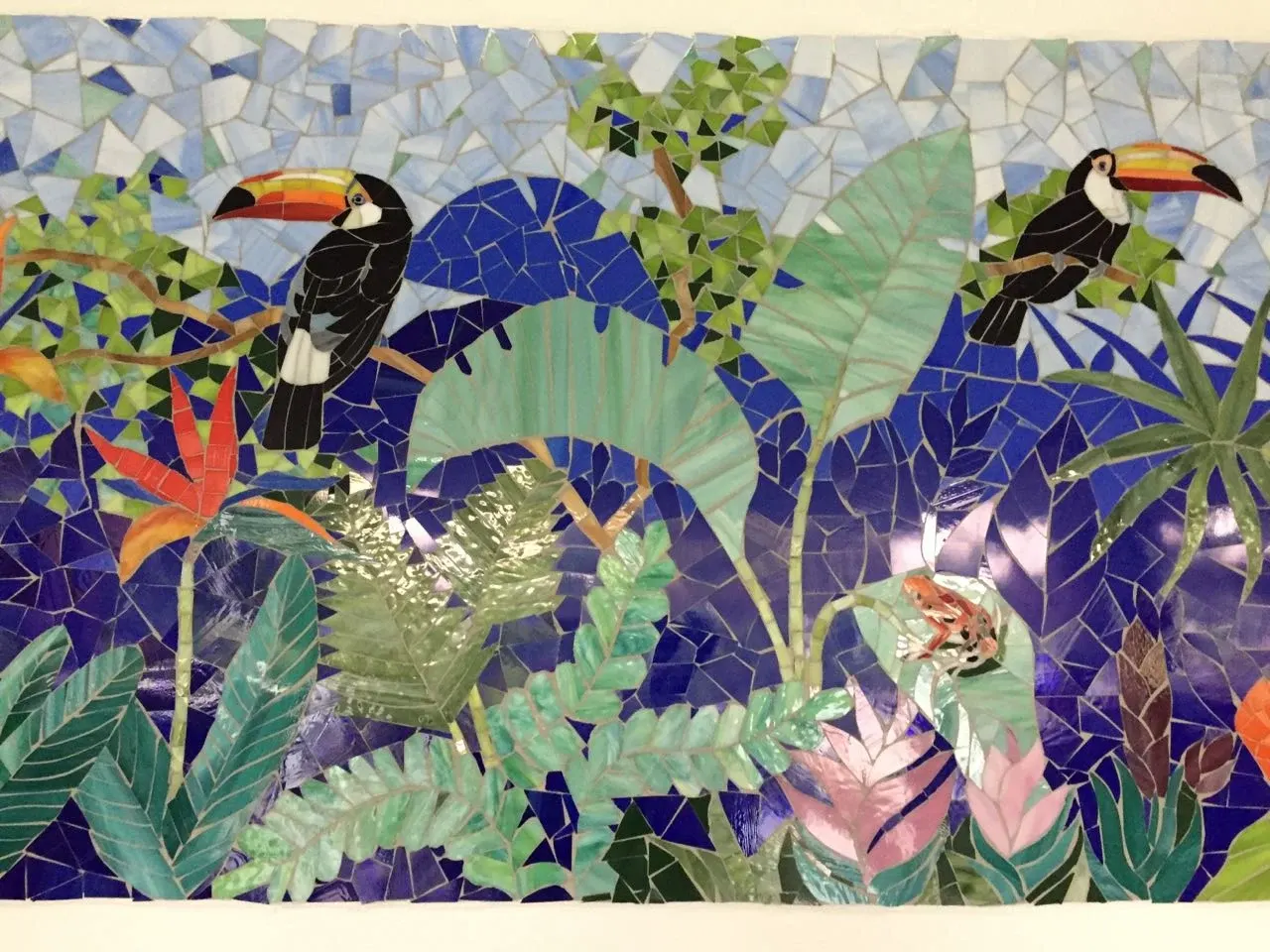 Tropical forest mosaic mural with toucans at a private residence in Ahmedabad